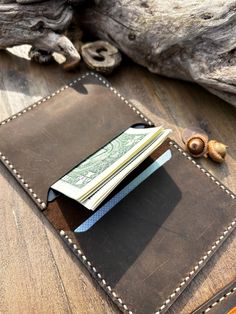 -Handmade Leather Wallet 📌Features: ⚬ Can hold 8-9 cards and cash ⚬ Made with high-quality genuine vegetable tanned leather ⚬ Handcrafted using old-fashioned techniques, no machines used 🟢Personalization Options: 🔻Initials 🔻Name 🔻Date 🔻Quote ---------------------------------------------------------- Natural Leather: 📍Please be aware that since our leather products are natural, there might be signs of stretch marks, bug bites and other marks on the leather. -------------------------------- Rectangular Wallets With Card Slots As Gift, Trifold Wallet With Interior Card Slots As Gift, Rectangular Trifold Wallet With Card Slots As Gift, Brown Card Holder With Coin Pocket As Gift, Rectangular Trifold Wallet With Coin Pocket As Gift, Classic Handmade Card Holder For Daily Use, Brown Card Holder With Coin Pocket For Gift, Trifold Wallet With Card Slots As Gift, Handmade Classic Trifold Wallets