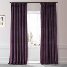 a purple curtain hanging in front of a window