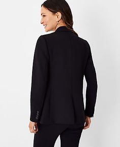 Elevate your professional wardrobe with the Ann Taylor Two Button Blazer in Double Knit. This blazer combines sophistication with comfort, featuring a stretchy, wrinkle-resistant fabric that ensures you stay sharp throughout the day. Perfect for mixing and matching, this piece is a versatile addition to any ensemble.

- Size: 00
- Color: Black
- Gender: Female
- Material: Shell - 78% Polyester, 15% Rayon, 7% Spandex; Lining - 100% Polyester
- Fit: Relaxed fit
- Length: Hits at hip, approximately Fitted Single-breasted Top For Office, Fitted Professional Tops, Stretch Outerwear With Button Closure For Work, Fitted Notch Lapel Versatile Blazer, Fitted Notch Lapel Tops For Work, Versatile Stretch Outerwear For Work, Versatile Fitted Formal Blazer, Fitted Single Breasted Top For Workwear, Fitted Single Breasted Business Tops