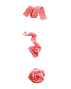 the letter s is made out of pink crepe paper and has a rose on it