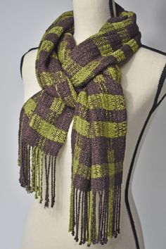 Brown + Green handwoven scarf styled on a mannequin Brown Handwoven Winter Scarves, Bohemian Brown Handwoven Scarves, Bohemian Brown Handwoven Scarf, Handwoven Brown Scarves For Fall, Brown Bohemian Woven Scarf, Green Yarn, Fringe Fabric, Black And White Scarf, Hand Painted Scarves