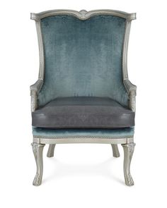 an upholstered chair with blue velvet on the back and grey leather seat padding