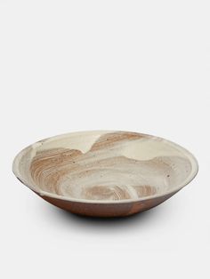 a brown and white bowl on a white background