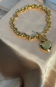 Stainless Steel Gold 7” bracelet with toggle clasp and heart charm. Non-Tarnish Water Resistant Hypoallergenic Perfect bracelet for the new season! Chunky Heart-shaped Jewelry Gift, Heart Shaped Bracelet With Toggle Clasp As Gift, Trendy Jewelry With Heart Pendant And Toggle Clasp, Heart Shaped Toggle Clasp Bracelet For Gift, Trendy Heart Pendant Jewelry With Toggle Clasp, Heart Charm Bracelet With Toggle Clasp For Gift, Heart-shaped Charm Bracelet With Toggle Clasp As Gift, Metal Heart Bracelet With Toggle Clasp As Gift, Valentine's Day Gift Bracelet With Toggle Clasp