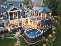 an aerial view of a house with a pool in the yard and decking area