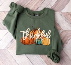 Thankful Sweatshirt, Pumpkin Season Sweatshirt, Thanksgiving Day Sweatshirt, Blessed Sweatshirt, Fall Sweatshirt, Autumn Sweatshirt, AKR350 If you want any color which is not listed please contact us. HOW TO ORDER: 1) Please Select Shirt Size and Style 2) Please Select Shirt Color 3) Please Type Your Customization 4) Add to Your Cart CARE INSTRUCTIONS - - Machine wash cold, inside-out, gentle cycle with mild detergent and similar colors. - Use non-chlorine bleach, only when necessary. No fabric softeners. - Hang-dry for longest life or tumble-dry on low. - Cool iron inside-out if necessary. Do not iron the design area. - Do not dry clean. Thankful Sweatshirt, Pumpkin Season, Pumpkin Seasoning, Fall Sweatshirt, Houston Tx, Shirt Color, Favorite Outfit, Sweat Shirt, Colorful Shirts