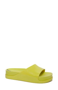 Stand out in the outstanding comfort and ease of this vividly colored flatform slide sandal with subtly debossed details and a mix of glossy and matte finishes. 2" heel; 2" platform Synthetic upper, lining and sole Made in Brazil Summer Slip-on Slides With Translucent Outsole, Modern Platform Slippers With Textured Sole For Beach, Summer Platform Slides, Modern Flat Slides With Textured Sole, Modern Synthetic Slides With Textured Footbed, Modern Green Slides For Summer, Modern Platform Jelly Sandals In Synthetic Material, Modern Platform Jelly Sandals In Synthetic, Modern Platform Jelly Sandals