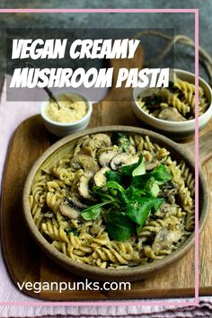 vegan creamy mushroom pasta in a bowl with spinach and parsley on the side