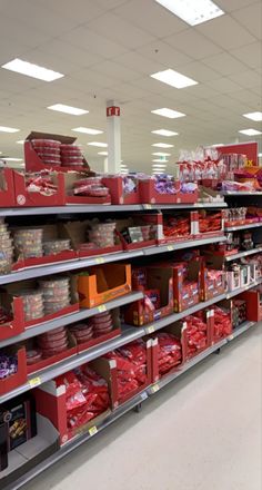 a store filled with lots of red and white boxes on the shelves next to each other