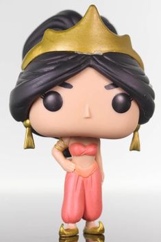 a close up of a figurine with a gold crown on it's head