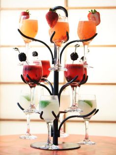 a table topped with glasses filled with different types of drinks