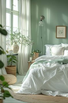 a bedroom with green walls and white bedding, potted plants on the floor