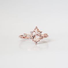 This ring is an elegant beauty for the ages. A peachy morganite set 14K solid gold. Definitely a timeless classic. Available in yellow gold vermeil, rose gold, and silver. Material: - 14K solid gold - Natural Morganite 7x5mm - Round CZs **This item is made to order, please allow 1-2 weeks for your order to be shipped. Shipping: Domestic: Ship via USPS priority mail International: $15 for international standard shipping. $10 to Canada. Online Return Policy: Due to the made to order nature, this r Classic Morganite Diamond Ring For Formal Occasions, Heirloom Morganite Diamond Ring For Formal Occasions, Classic Morganite Diamond Ring With Center Stone, Formal Rose Gold Morganite Diamond Ring, Elegant Morganite Diamond Ring With Gemstone, Classic Morganite Diamond Ring In Yellow Gold, Elegant Morganite Solitaire Rings, Elegant Solitaire Morganite Rings, Classic Morganite Diamond Ring With Round Cut