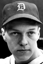 a black and white photo of a baseball player wearing a hat with the detroit tigers on it