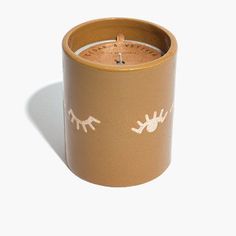 a candle that has eyes drawn on it