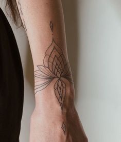 a woman's arm with a tattoo on it, and a flower in the middle