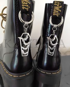 How amazing are these gothic shoe charms? - Durable rings that easily open and close, allowing for effortless attachment to any footwear.  - Perfect for adding flair to old boots or spicing up new shoes.  -Style rhem with goth dresses, grunge, punk, or metal outfits. -Perfect for both old and new shoes. Be bold and add a unique touch to any pair of footwear. - Available in 4 styles: Crescent Moon, bats, swords and coffins Price is for a pair of charms. Metal Outfits, Dresses Grunge, Goth Dresses, Alt Shoes, Metal Outfit, Goth Shoes, Gothic Shoes, Old Boots, Goth Dress