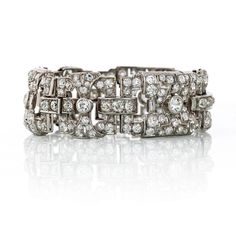 Beautiful 1930's Art Deco bracelet crafted in Platinum set with old European cut diamonds of 22 carats total weight. This bracelet is light and elegant. Truly a beautiful showcase of the Art Deco era.Details: Art Deco Open Work 22 carats DiamondTotal Carat Weight: 22.00Measurements: 7 InchesMetal Type: PlatinumMetal Weight: 55.4 gr.Condition: Vintage. Good.Stock: RR5982 Emerald Cut Diamond Ring, Art Deco Bracelet, Platinum Metal, Deco Jewelry, European Cut Diamonds, Art Deco Era, Antique Diamond, Women Diamond, Bracelet Crafts