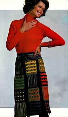 a woman in a red shirt and multicolored skirt