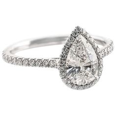 a pear shaped diamond ring with pave diamonds on the band