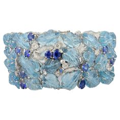 This Regal 133.15 CTW Aquamarine Sapphire Wide Bracelet for Wedding in 18K gold showcases 133.15 carats endlessly sparkling natural aquamarine nd sapphire and 1.95 carats of diamond. It measures 7.5 inches long in length. Aquamarine is useful for moving through transition and change and sapphire stimulates concentration and reduces stress. Designed with carved aquamarine and mixed cut sapphires and diamond set in solid gold to make you stand out on any occasion or event. The elegant style comple Luxury Multi-stone Diamond Bracelet, Luxury Multi-stone Diamond Bracelet For Formal Occasions, Luxury Multi-stone Tennis Bracelet For Anniversary, Luxury Multi-stone Tennis Bracelet For Formal Occasions, Luxury Multi-stone Cubic Zirconia Diamond Bracelet, Luxury Cubic Zirconia Multi-stone Diamond Bracelet, Luxury Multi-stone Diamond Bracelet For Wedding, Elegant Diamond Multi-stone Bracelets, Elegant Multi-stone Diamond Bracelets