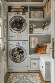 a washer and dryer sitting in a closet next to each other with towels on the shelves