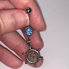 Light Blue Gem Nautical Wheel Design Dangle Belly Ring These Belly Rings Have A Ships Wheel Charm That Dangle From A 14 Gauge Belly Ring. These Are Made With A Sturdy Split Ring So Your Charm Does Not Fall Off Like Other Cheap Belly Rings. I Use A Split Ring On Them As A Jump Ring Can Break Away Too Easily. This Way The Charms I Attach Stay Longer And You Are Less Likely To Break Them Off. #Handmade #Bellyring #Navelring #Shipswheel #Wheel #Nautical Blue Nautical Jewelry For Gift, Blue Nautical Style Jewelry For Gift, Blue Nautical Style Jewelry Gift, Blue Nickel-free Stainless Steel Jewelry, Blue Stainless Steel Nickel-free Jewelry, Adjustable Blue Nautical Jewelry, Adjustable Nautical Blue Jewelry, Silver Nautical Jewelry With Adjustable Fit, Adjustable Nautical Silver Jewelry