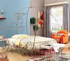 a bed room with a neatly made bed and orange chairs