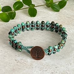 A deep green African Turquoise macrame bracelet combined with copper Hematite, all on soft green cord and finished off with a Copper TierraCast Tree of Life button. Such a great natural colour! 💫 - Measures approx 17cm/6.75"  - 4mm round African Turquoise - 4mm copper Hematite - Copper TierraCast Tree of Life button - Jewellery grade knotting cord Jasper - African Turquoise: The "Stone of Evolution."  It encourages growth and development to foster positive change from within.  It opens the mind to new ideas and endless possibilities. Believed to help ease mood swings & encourage a more optimistic attitude towards life. (Heart, throat & Third Eye Chakras)✨ Hematite: Protects, stabilises and grounds. Increases confidence, clarity and mental organisation. Shifts negative energy out of the au Button Jewellery, Jewellery Unique, African Turquoise, Macrame Bracelet, Uk Gifts, Button Jewelry, Macrame Bracelets, Mood Swings, Positive Change