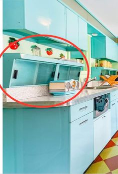 a kitchen with blue cabinets and an orange floor in the middle is circled by a red circle