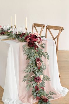 the table is decorated with flowers and greenery