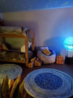 a room with bunk beds, rugs and other items on the floor in front of it