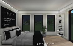 a bedroom with black and white decor in the night time, along with large windows