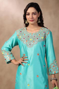 Light blue short kurta with multi colored resham embroidery. Comes with matching sharara and leheriya dupatta.
Components: 3
Pattern: Embroidered
Type Of Work: Sequins, Pearls, Gota Patti, Resham
Neckline: Round
Sleeve Type: Long
Fabric: Silk
Color: Blue
Other Details: 
Attached lining
Scalloped hem dupatta
Approximate product weight: 0.5-1 kg
Occasion: Mehendi and Haldi - Aza Fashions Leheriya Dupatta, Resham Embroidery, Short Kurta, Women Kurta, Light Blue Shorts, Straight Kurta, Sharara Set, Fabric Silk, Scalloped Hem