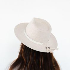 We love this white leather hat band! This hat band features a tie back with tassels trimmed with metal GP engraved caps. This hat band is made of genuine leather. Simply place this leather band around the crown of your hat and tie the strings into a knot to keep in place. Let the tassels hang down. Shop more hat bands here. White Adjustable Fedora With Flat Crown, Adjustable White Fedora With Flat Crown, Adjustable Flat Brim Hat With Fringe, Adjustable Beige Felt Hat For Festival, Adjustable Cream Felt Hat For Country Events, Festival Cream Hat Bands, Adjustable Cream Fedora For Festivals, Trendy Adjustable White Hat Bands, White Adjustable Hat With Flat Crown