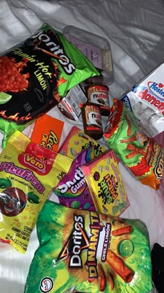 various snacks are laid out on a bed