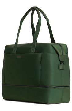 a green leather bag with handles and straps on the front, sitting upright against a white background