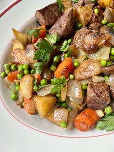 a white plate topped with meat and veggies