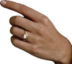 a woman's hand with a ring on it and a diamond in the middle