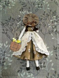 the doll is wearing a dress and holding a basket with flowers in it's hand