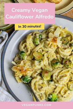 creamy vegan cauliflower alfredo on a white plate with a pink and yellow border