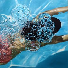 a man swimming in the water with bubbles