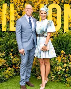 a man and woman standing next to each other in front of a sign that says happy 90