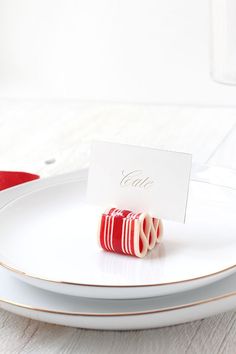 red and white candy on a plate with a place card