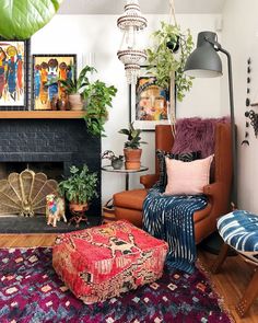 a living room filled with lots of furniture and plants on top of a fireplace mantel