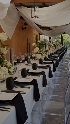 the tables are set with black and white place settings