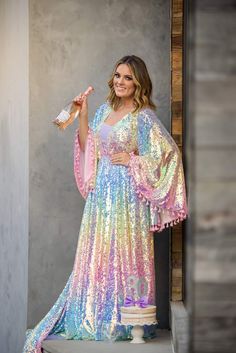 Our beautiful “Rainbow Disco" gown was designed after our own designers love for bohemian vibes and all things lace. This gorgeous gown is made with a beautiful pastel sequin fabric. We have added an elastic waist to the dress which adds extra sizing capabilities. Flair sleeves adorned with pink tassels. We have also added tassels to her back of bodice. This dress can easily size up and down. Dress comes with a detachable slip-Slip is exact measurements provided-so there is no give/stretch. You Up And Down Dress, 70s Fashion Women, Flair Sleeves, Rainbow Wedding Dress, Tie Dye Fashion, Fairytale Fashion, Bohemian Vibes, Rainbow Dress, Princess Outfits