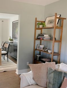 a living room filled with furniture and a book shelf