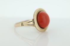 Amazing Statement ring. 8k yellow gold set with a Deep Orange CORAL cabochon gem. The Coral is round cabochon Condition: Shows little signs of wear. Details: 11mm orange Coral 16mm Round top table 8mm rise off finger 5.0grams total weight Marked 333 (8K) Size 8 Formal Round Gemstone Cabochons, Formal Fine Jewelry Domed Cabochons, Formal Domed Cabochons Fine Jewelry, Gold Domed Gemstone Cabochons, Domed Gold Gemstone Cabochons, Modern Jewelry With Oval Cabochon Bezel Setting, Modern Jewelry With Bezel Set Oval Cabochon, Yellow Gold Round Cabochon Jewelry, Yellow Gold Cabochon Jewelry