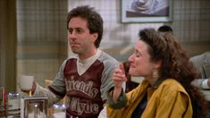 a man and woman sitting at a table with cups in front of them on the tv show friends